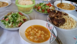 Abendessen mit Kartoffelsuppe, Salat, Nudeln und Fleisch.